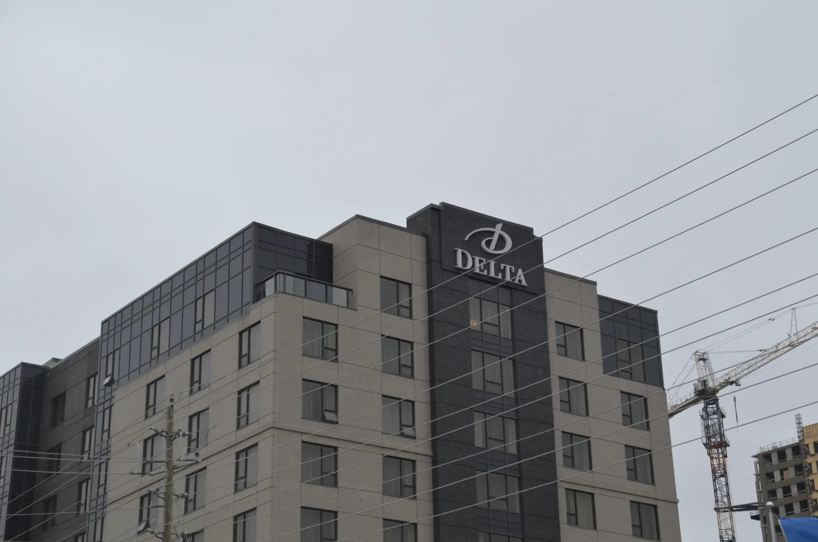 High-rise residential tower beside a completed hotel