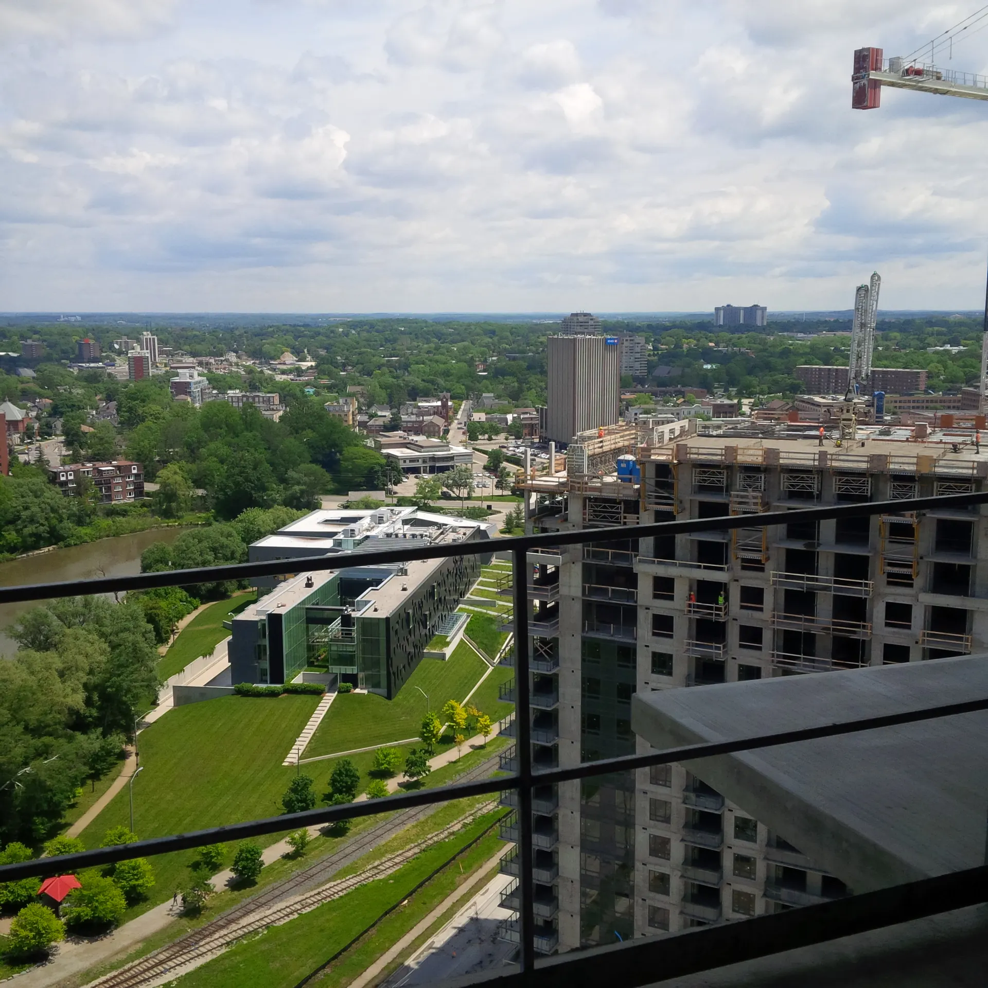 Aerial view over a Waterloo Region neighbourhood from a high-rise jobsite