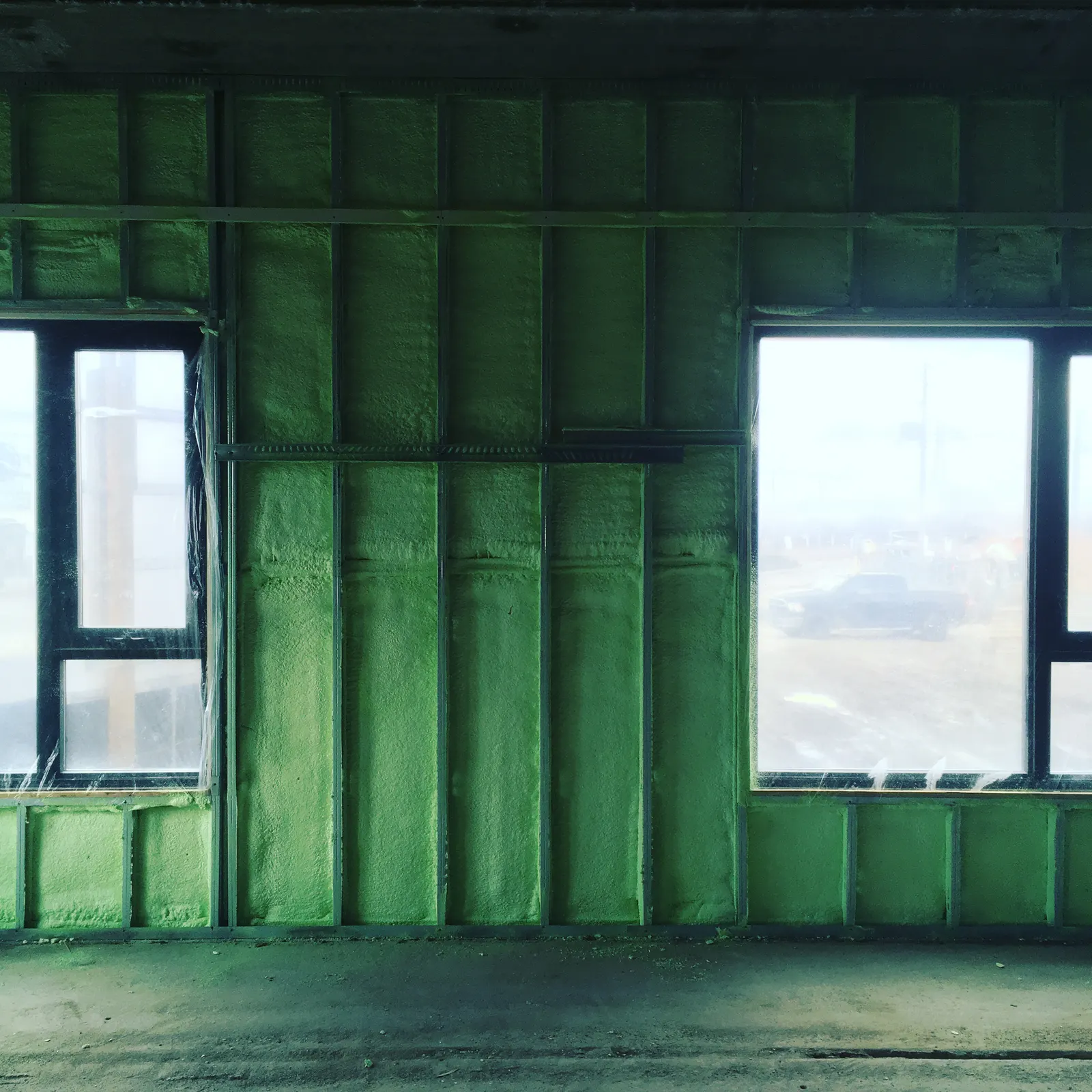 Spray foam insulation applied to interior walls around windows